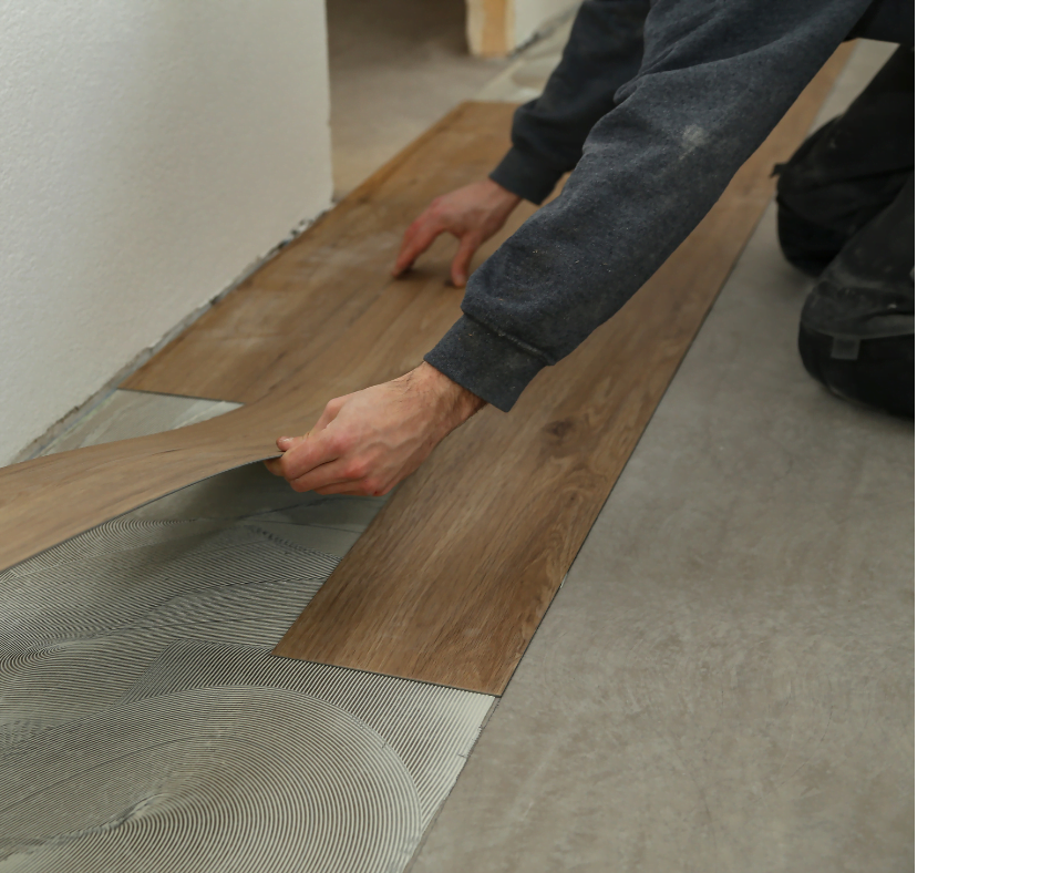 Person laying down laminate flooring planks